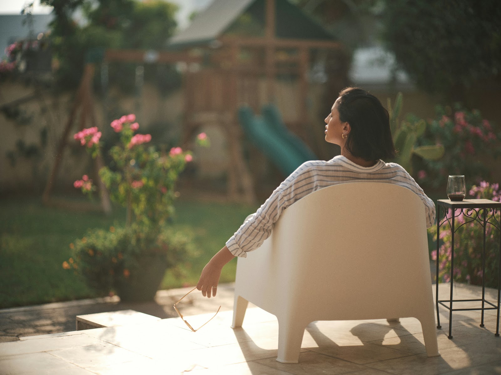 Mom prioritising self care Woman sitting on the porch sun bathing