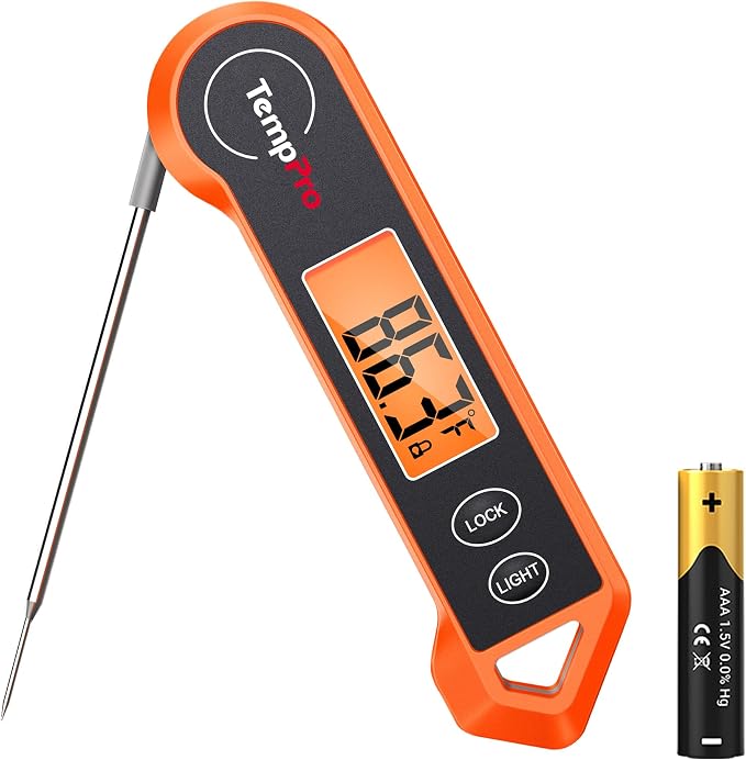 Orange digital instant read meat thermometer with a folding probe and a battery beside it
