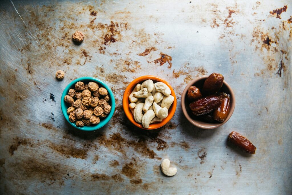 Oat, date and nut snack ingredients in small bowls
