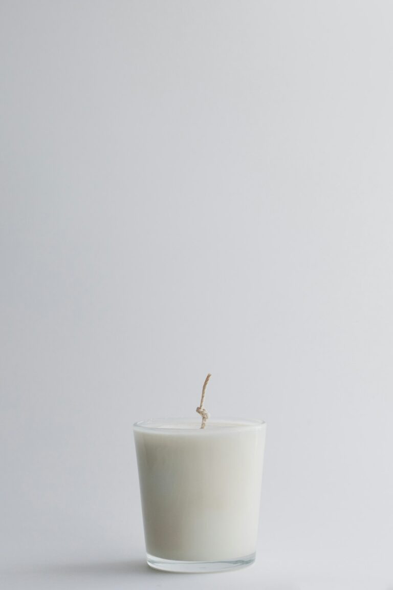 A white candle in a glass jar