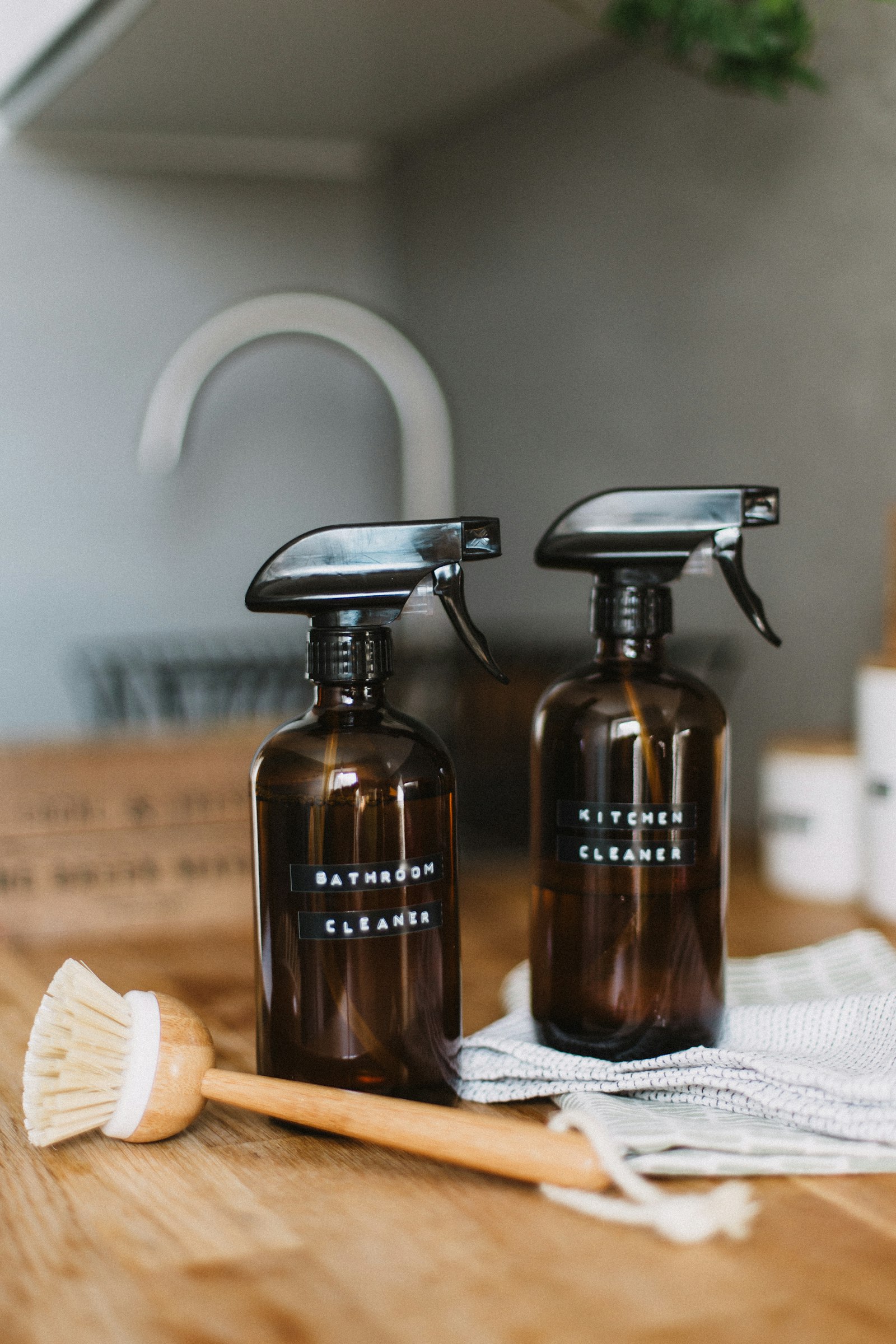 Two brown spray bottles on a table for simple cleaning