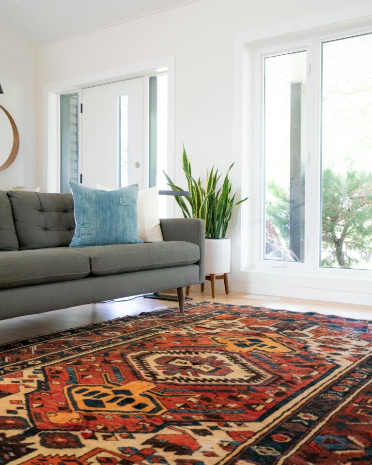 A living room with a red area rug